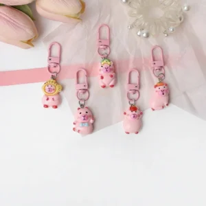 Set of 5 pink resin capybara keychains with matching pink clasps on a white background.
