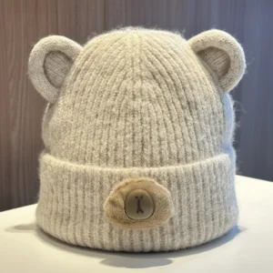 A beige fleece-lined capybara beanies with cute button noses.