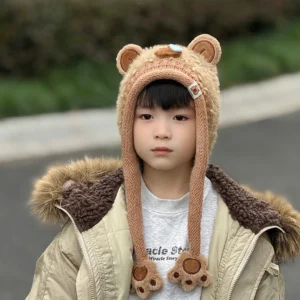 Child modeling a kids curly sherpa capybara hats featuring a funny blue nose bubble design and fuzzy paw earflaps