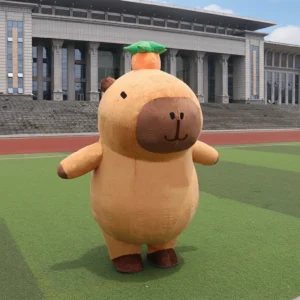 Two giant plush inflatable capybara mascot costumes standing on a blue walkway, featuring cute round bodies and orange accessories on their heads.
