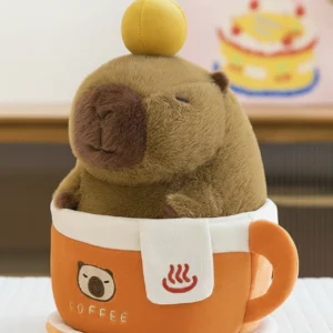 A fluffy brown capybara plush with an orange on its head sitting inside a removable orange coffee cup plush toy with an embroidered bear face.