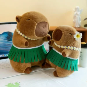 A cute brown capybara plush toy standing up, wearing a green hula skirt, a daisy necklace, and a white flower behind its ear.