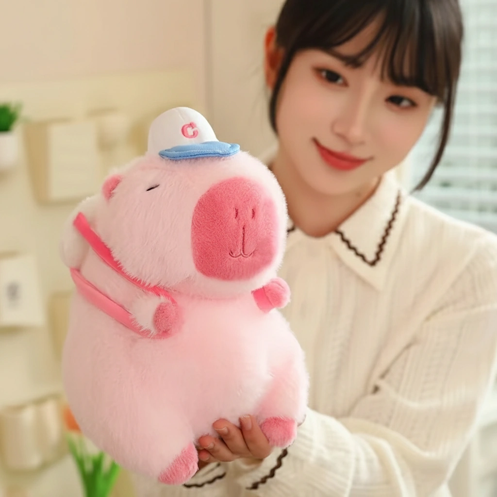 pink capybara plush toy with baseball cap