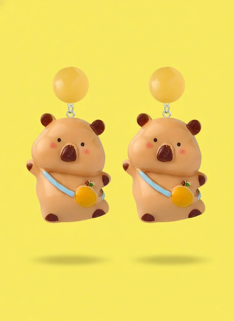 Large vibrant dopamine orange capybara dangle earrings featuring a 3D capybara with a giant orange, available in silver needles and clip-on styles.