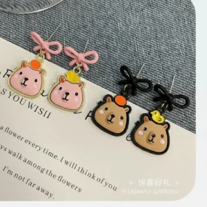 Adorable capybara face stud earrings available in pink, white, and black colors with S925 silver needles and two types of comfortable clip-on backings.