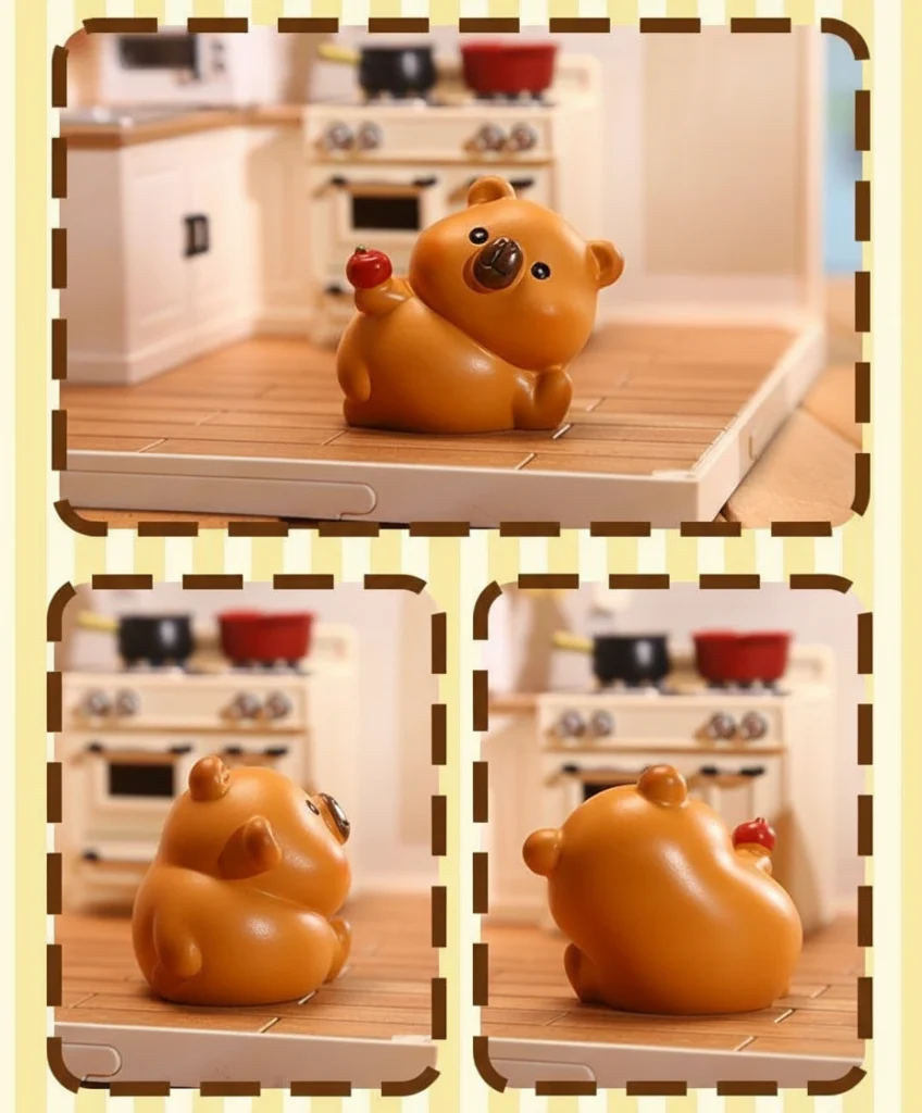 A set of four brown resin capybara mini figures in various cute poses, including one wearing a crown and one with an orange on its back, displayed in a miniature kitchen setting.