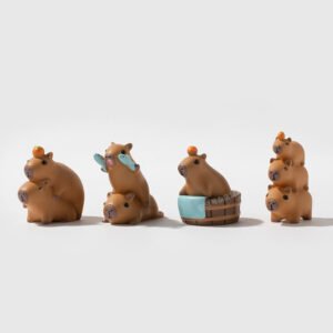 A collection of seven different miniature capybara figures in various poses including riding a duck, stacking on each other, and sitting in a wooden bathtub.