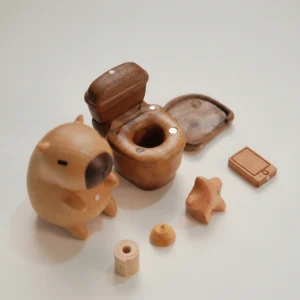 A 7-piece modular wooden-textured capybara figure sitting on a toilet checking a phone, showing the magnetic detachable parts disassembled and assembled.