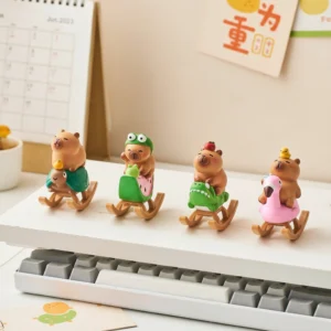 A set of six miniature capybara figures, each sitting on a different colored rocking horse like a playground toy, in a variety of poses.