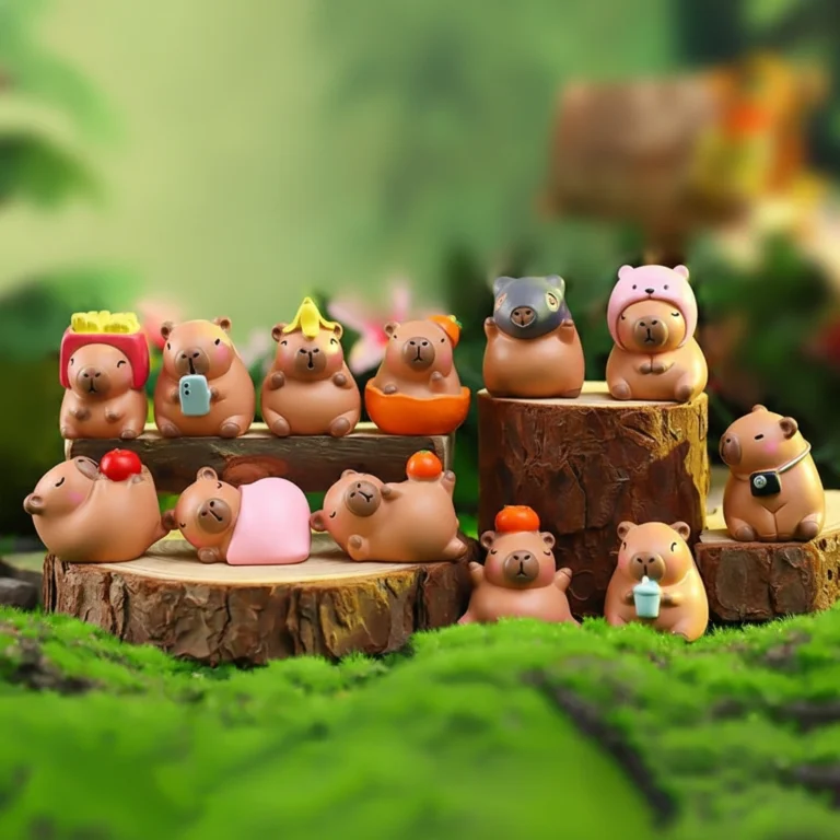 A set of 12 different resin capybara figures in various poses, including some with oranges on their heads and others lying down.