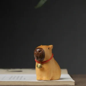 A 5cm hand-carved dark sandalwood capybara figurine with a smooth natural wood grain, standing on a flat surface.