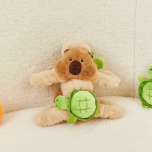 Close-up of a double-sided plush hair claw clip featuring a brown capybara face on one side and a green turtle plush on the other.