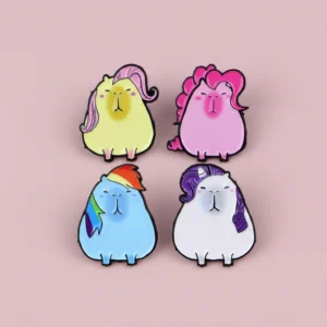 Set of four enamel pins featuring capybaras styled as magical ponies with rainbow, pink, purple, and yellow manes.