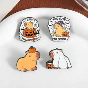 Set of four Halloween-themed enamel pins featuring a capybara in a ghost costume, wearing a witch hat, sitting inside a pumpkin, and balancing a pumpkin on its head.