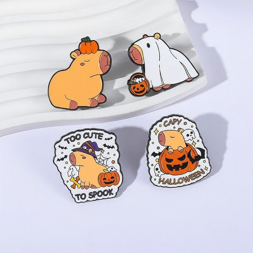 Set of four Halloween-themed enamel pins featuring a capybara in a ghost costume, wearing a witch hat, sitting inside a pumpkin, and balancing a pumpkin on its head.