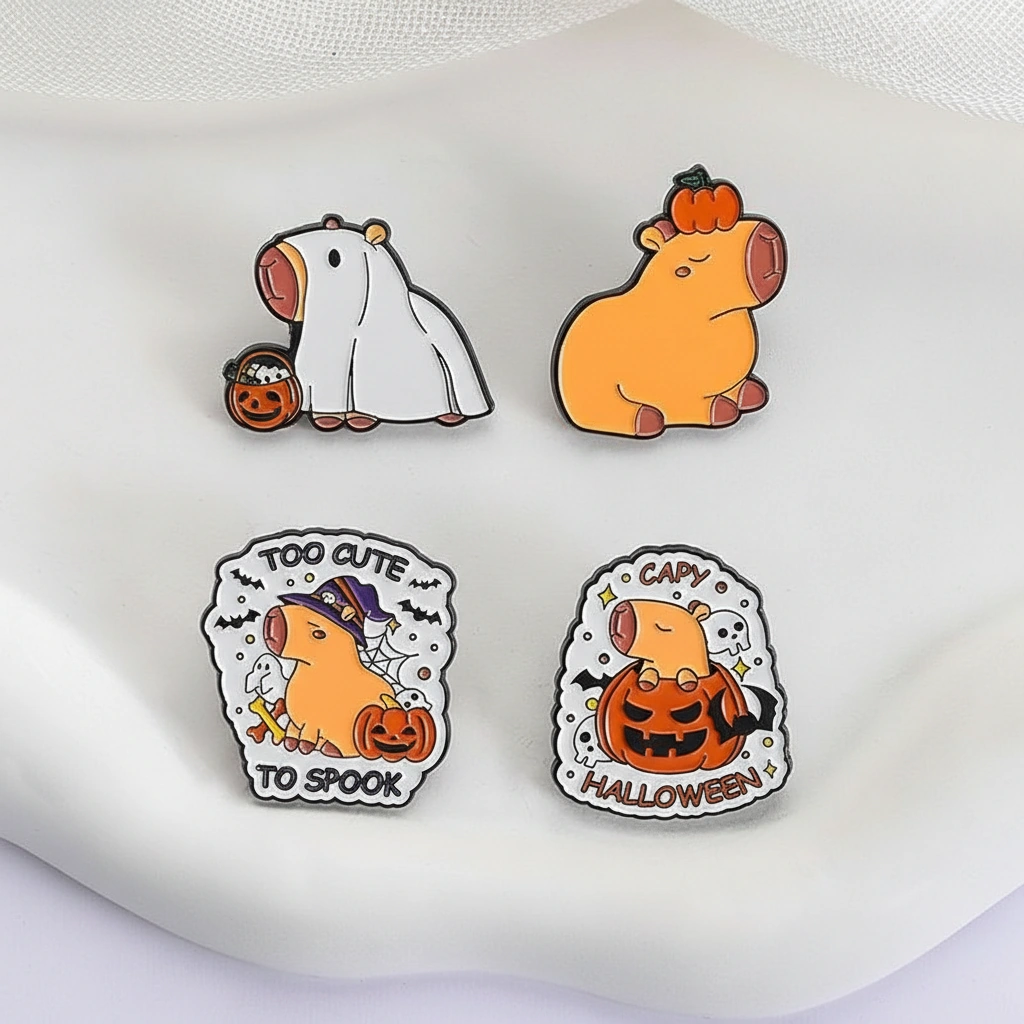 Set of four Halloween-themed enamel pins featuring a capybara in a ghost costume, wearing a witch hat, sitting inside a pumpkin, and balancing a pumpkin on its head.