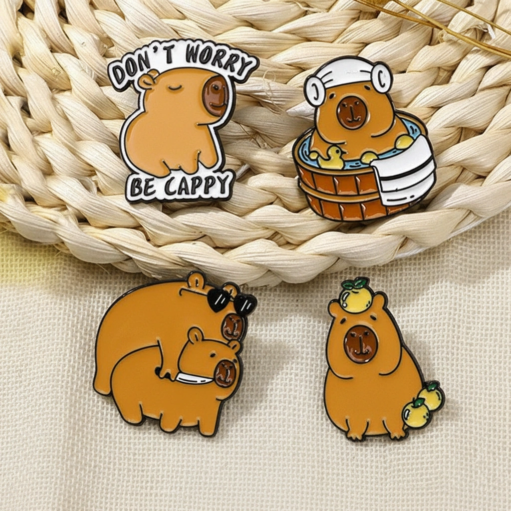 Set of four enamel pins featuring a capybara in a spa tub with ducks, one in a hoodie, one balancing fruit, and a funny duo with sunglasses and a knife.