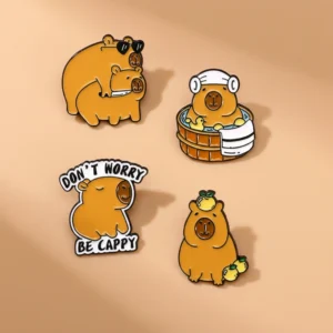 Set of four enamel pins featuring a capybara in a spa tub with ducks, one in a hoodie, one balancing fruit, and a funny duo with sunglasses and a knife.