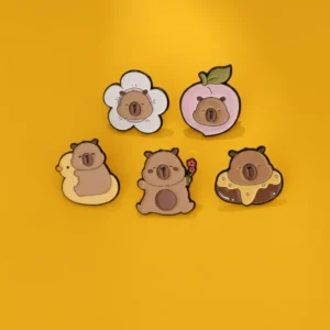 Set of five kawaii enamel pins featuring a round capybara inside a peach, a chocolate donut, a white flower, a yellow duck floatie, and holding red flowers.