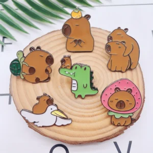 Set of six enamel pins featuring a capybara riding a pelican, sitting on a crocodile, carrying a turtle, wearing a strawberry costume, balancing an orange, and hugging another capybara.