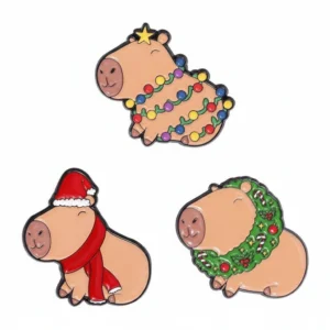 Set of three Christmas-themed enamel pins featuring a capybara in a Santa outfit, one wearing a holiday wreath, and one wrapped in colorful string lights.