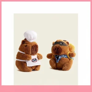 Close-up of a cute capybara plush keychain available in two styles: one wearing a white chef hat and apron, and the other wearing a black bandit mask and blue bandana with a bread loaf.