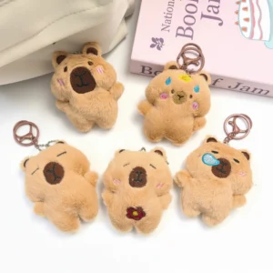 A collection of five 9cm brown capybara plush keychains showing different emotions, including sleeping, holding a flower, and having a snot bubble.