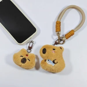 Both styles of capybara phone straps displayed together next to a mobile phone.