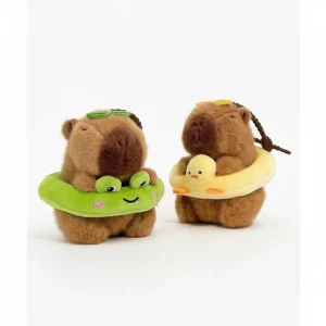 Two capybara plush keychains standing together wearing yellow duck and green frog plush swim rings.