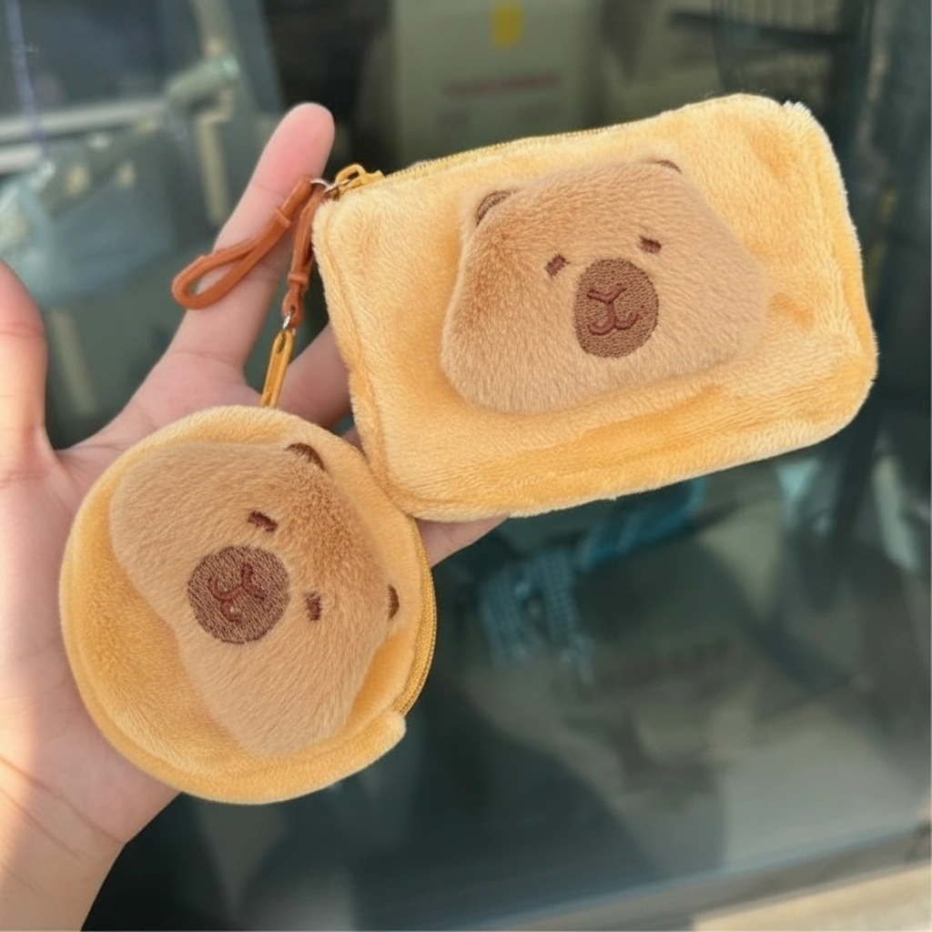 Soft yellow plush capybara wallet coin purse shown in square and round shapes, featuring a 3D brown snout and hanging clip.