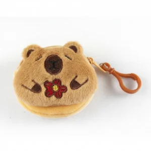 Honey-brown plush capybara coin purse with a happy smiling face, holding a red flower